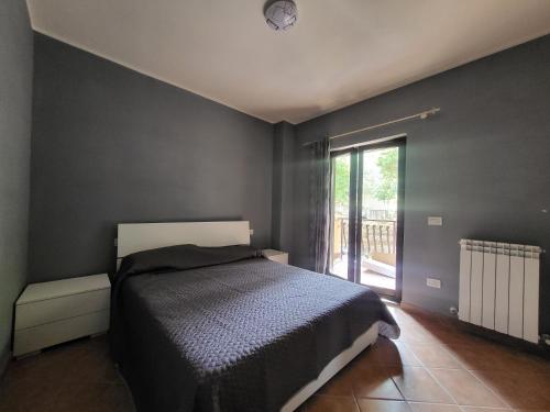 a bedroom with a bed with a clock on the wall at Locazione Turistica Vista Torricella in Torricella in Sabina