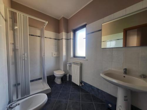 a bathroom with a sink and a toilet and a shower at Locazione Turistica Vista Torricella in Torricella in Sabina