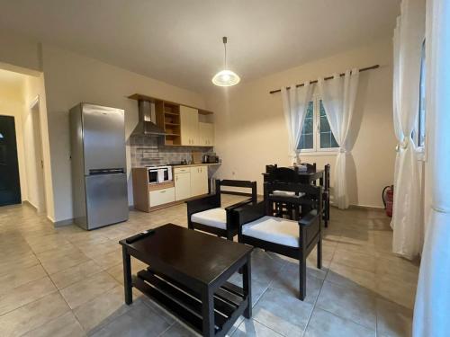 a kitchen with a table and chairs and a refrigerator at Theros Retreat in Spartia