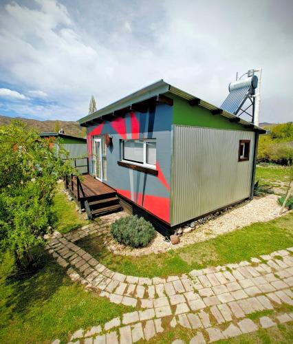 a house with a painting on the side of it at CASA FARO ARTE in Potrerillos