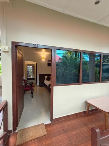 a living room with a door open to a bedroom at Yerrata Resorts in Havelock Island