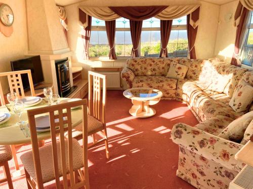 a living room with a couch and a table at Anchor's Drop in Blue Anchor