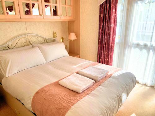 a bed with two pillows on it in a bedroom at Anchor's Drop in Blue Anchor