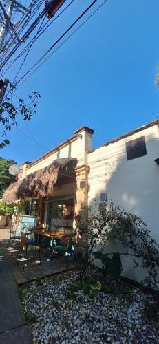 a house with a table and chairs in front of it at Yolo Hostel Medellin in Medellín