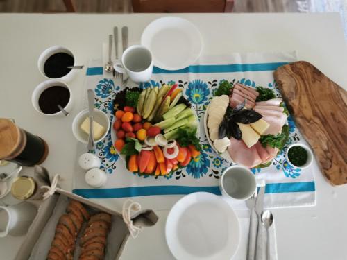a table with plates of food on a table at Dom w Siedlisku pod Orzechem in Przyłęk