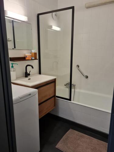 une salle de bain avec une douche, un lavabo et une baignoire dans l'établissement Le refuge, à Samoëns