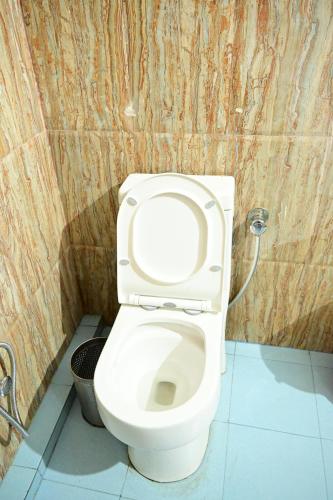 a bathroom with a white toilet in a stall at Hotel Fotiya jaisalmer in Jaisalmer