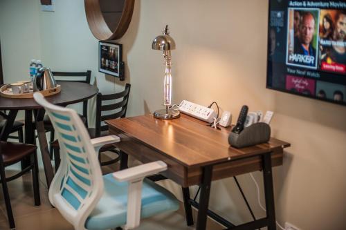 a table with a lamp and a phone on it at Paladium Iloilo Smart Home Condo in Iloilo City