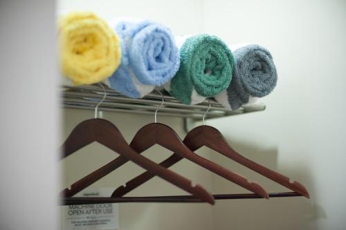 a rack with yarn and towels on it at Paladium Iloilo Smart Home Condo in Iloilo City