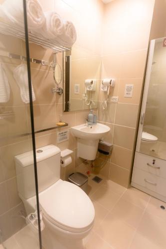 a bathroom with a toilet and a sink at Paladium Iloilo Smart Home Condo in Iloilo City