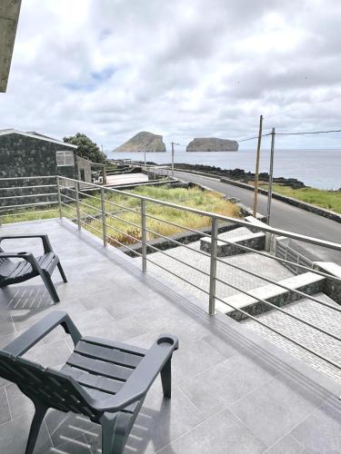 a patio with two chairs and a view of the ocean at Miramar in Angra do Heroísmo