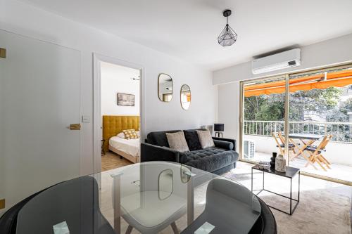 un salon avec une table en verre et un canapé dans l'établissement CANNES 2 P avec terrasse PROCHE Hôtel Martinez, à Cannes