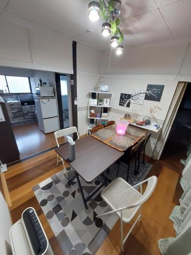a dining room with a table with a laptop on it at つきびとはうす in Satte