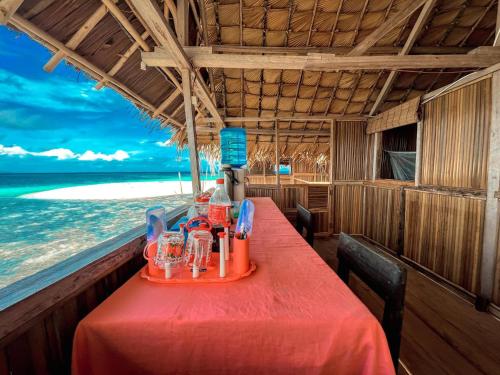 a table in a restaurant on the beach at Tamaku homestay in Minyaifuin