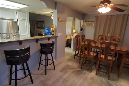 a kitchen and dining room with a table and chairs at Bikini & Martini on Palm Meadows Drive in Indio