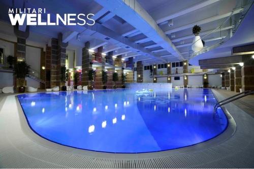 a large swimming pool with blue lighting in a building at MilitariResidence Luxury 54 in Roşu