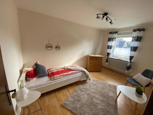 a living room with a bed and a window at Ferienwohnung an der Nordsee in Schortens