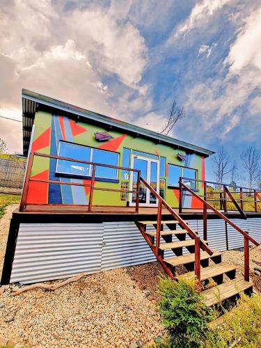 a house with a painting on the side of it at CASA FARO ARTE in Potrerillos