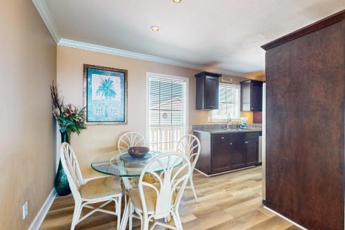 a kitchen and dining room with a table and chairs at Dawn Condominiums - Break of Dawn in Galveston