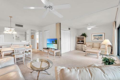 a living room with a couch and a table at Enit Unit -Close to Elevator and Pool Views in Naples