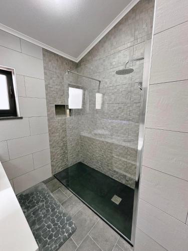 a shower with a glass door in a bathroom at Miramar in Angra do Heroísmo