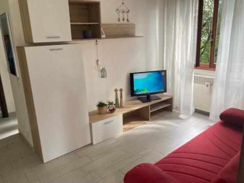 a living room with a refrigerator and a tv at Casa Chiara tra Saronno e Milano in Saronno