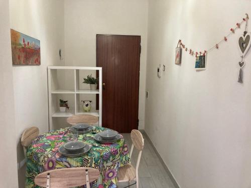 a dining room with a table with plates on it at Casa Chiara tra Saronno e Milano in Saronno