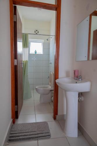 a bathroom with a sink and a toilet at LTM Stays ,Buxton Point , Mombasa in Mombasa