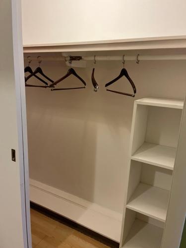 a walk in closet with shelves and hangers at Grand Lake Hotel in Lebanon