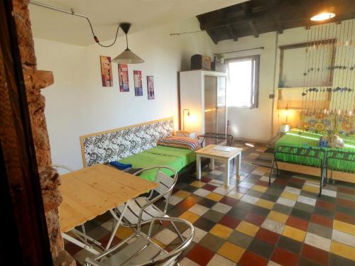 a living room with a table and a green couch at Solsicily in Catania