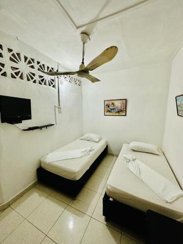 Postel nebo postele na pokoji v ubytování Hostal La Española de Getsemani