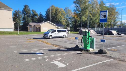 a white car is parked in a parking lot at Räpina Guest Apartment in Räpina