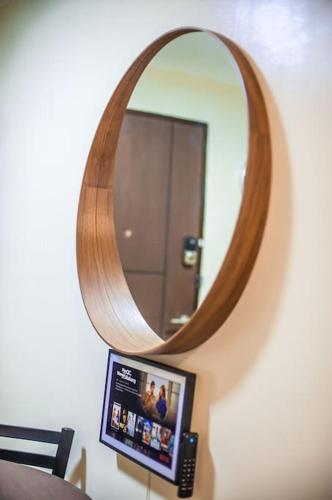 a mirror on a wall with a laptop in front of it at Paladium Iloilo Smart Home Condo in Iloilo City