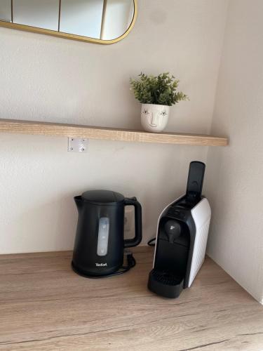 a coffee maker and a toaster sitting on a shelf at ART - Apartments by Alfi with Balcony & FREE Parking in Brixlegg
