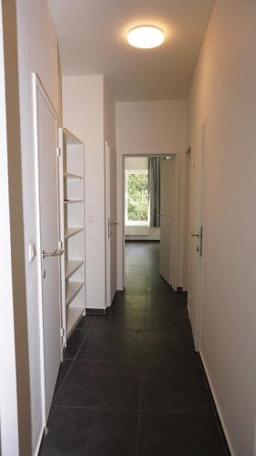 an empty hallway with a door and a window at Consci apartments in Antwerp