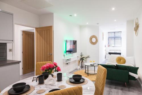 a living room with a table and a couch at Opulent Residence - 1 BR Leicester City Centre in Leicester
