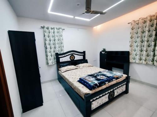 a bedroom with a black bed in a room at Skyline View Suite in Hyderabad