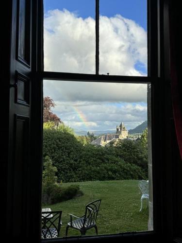 a window with a view of a rainbow seen through it at Wellwood Manor in Pitlochry