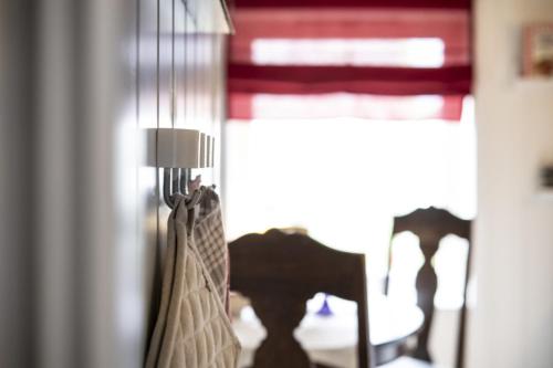 a room with a table and a lamp and a chair at Koselig leilighet i sentrum in Ålesund