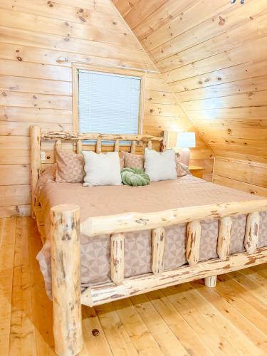 a bedroom with a large bed in a log cabin at Romantic Notions in Sevierville