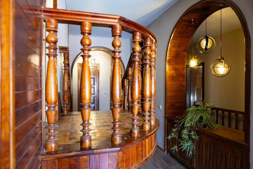 a wooden spiral staircase in a house at Hotel Horizont Telavi in Tʼelavi