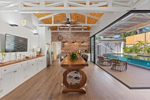 a kitchen and living room with a swimming pool at Swim-Through Glass Pool Villa, 5min Beach in Playa Flamingo