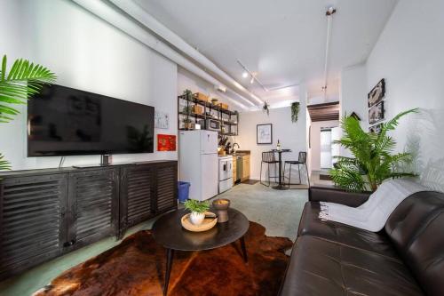 a living room with a couch and a table at Chic & Cozy Loft near Rogers Place, LRT, Jasper Ave in Edmonton