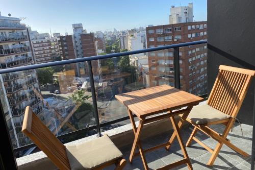 a table and chairs on a balcony with a view at EUGE Apart in Montevideo