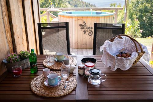 a table with plates of food and a basket of eggs at Johanca in Obrov