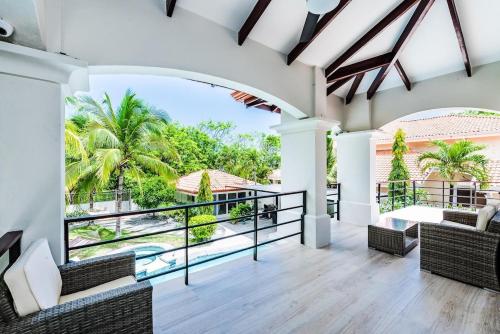 a view from the living room of a house with a balcony at Barefoot Beachfront, Pool, Surf & Private Casita in Playa Grande