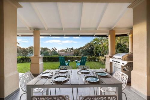 a wooden table and chairs on a patio at Charming 2BR - 2BA Condo Steps to the Beach in Tamarindo