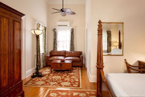 a living room with a couch and a mirror at The Gardens Hotel in Key West