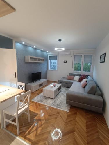 a living room with a couch and a table at ZONA apartman in Vranje