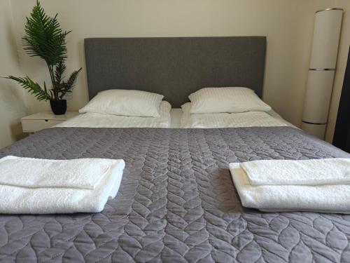 a bedroom with a bed with two white towels on it at Lovely 2R apartment, parking in Oulu